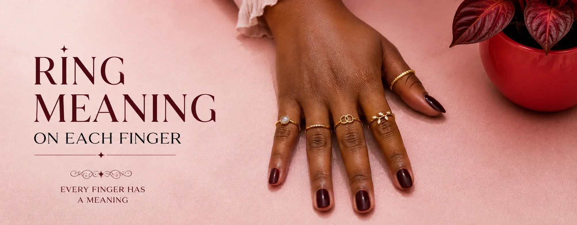 Ring meaning on each finger illustrated with a woman's hand wearing rings on every finger on a soft pink background.