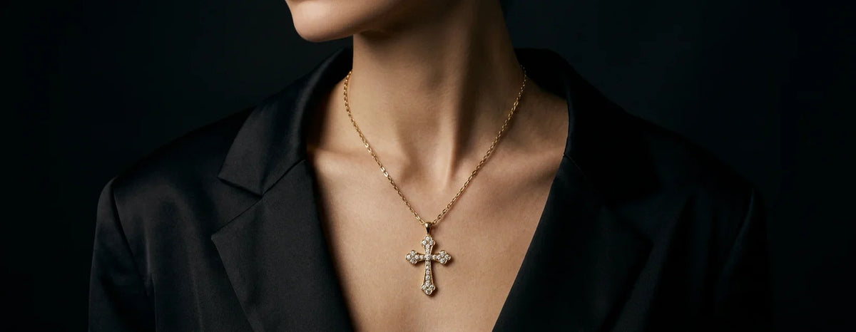 A man wearing a diamond cross pendant 