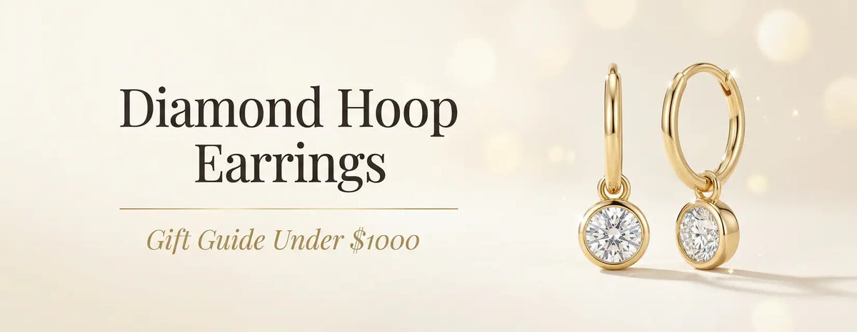 Gold huggie hoop earrings with dangling round diamonds, styled for the Diamond Hoop Earrings gift guide under $1000.