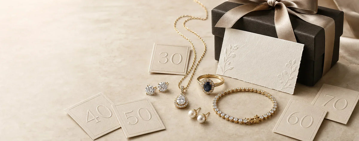 Fine jewelry arranged with subtle milestone birthday numbers and a gift box for a milestone birthday celebration.