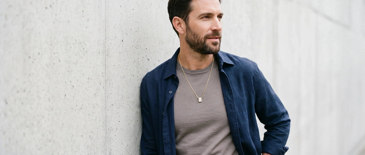 Man wearing a diamond pendant necklace with a contemporary casual outfit