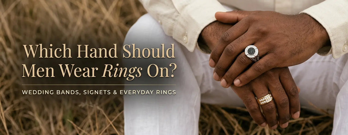 Two men's hands clasped, one wearing a diamond signet ring and the other a yellow gold diamond wedding band