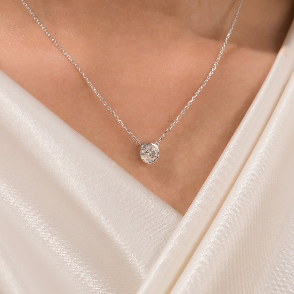 Model wearing an elegant Round Diamond necklace with a bezel-set solitaire diamond on a fine 18K white gold chain.