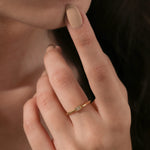 Dainty modern gold stacking ring with an east west baguette diamond bezel set wedding band