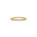 This yellow gold ring displayed on front view is made with brilliant round diamond and baguette diamond set in prong setting