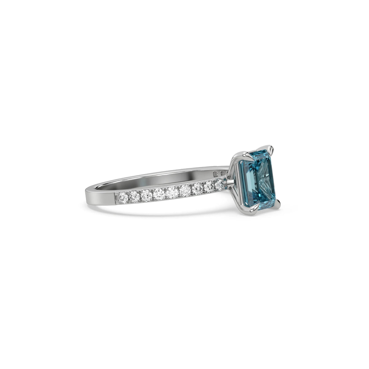 This white gold ring displayed in side view is made with a emerald solitaire diamond set in four-prong setting