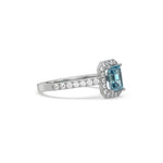 This white gold ring displayed in side view is made with a Emerald solitaire diamond set in four-prong setting