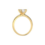 This yellow gold ring features a cushion solitaire diamond elegantly secured in a four-prong setting on a solid gold band in through finger view