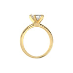 This yellow gold ring features an emerald solitaire diamond elegantly secured in a four-prong setting on a solid gold band in through finger view