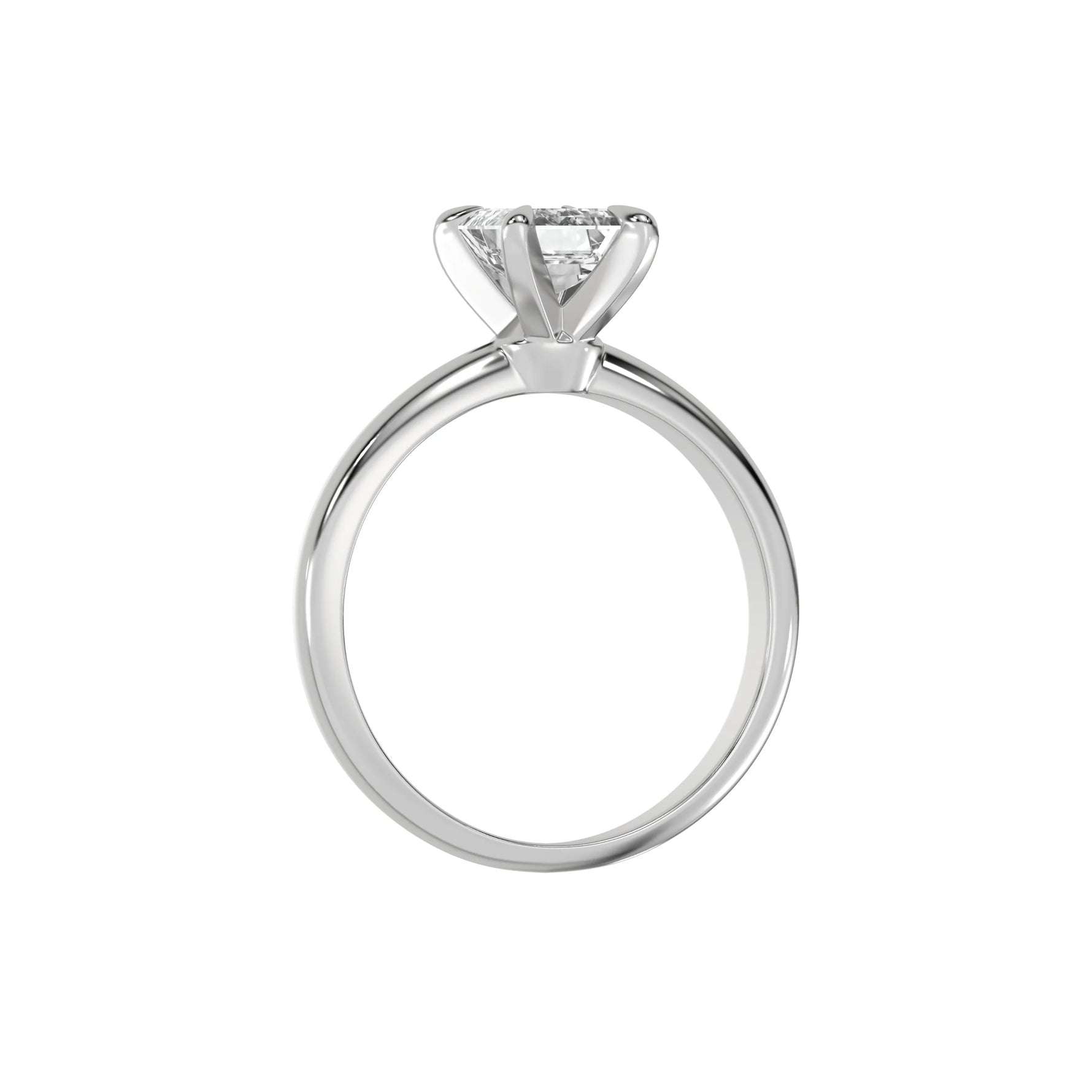 This white gold ring features an emerald solitaire diamond elegantly secured in a four-prong setting on a solid gold band in through finger view