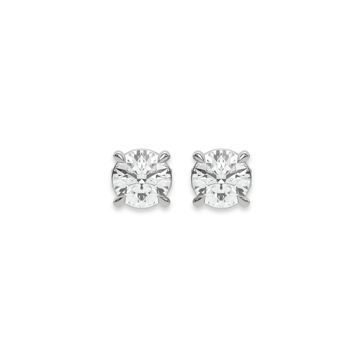 Close up of a pair of earrings featuring a Round diamond stud earring in prong-set and white gold on a white background.