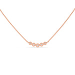 This rose gold Necklace with five round diamonds arranged in gradually decreasing sizes from the center, each securely set in bezel in top view