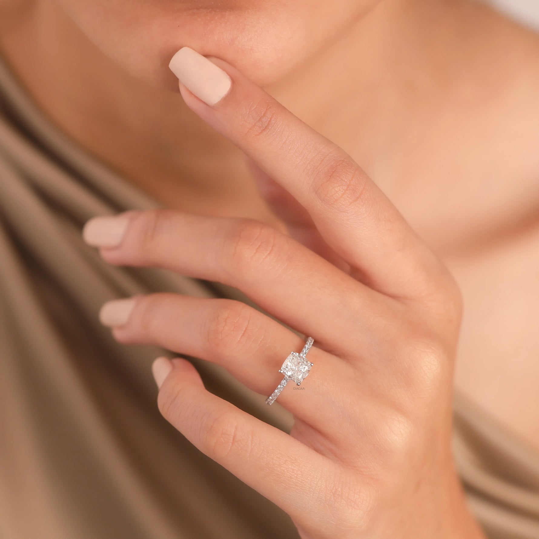 White gold wedding ring showcasing a classic cushion modified brilliant diamond focal stone on a delicate shank accented with radiant micro pave set diamonds.