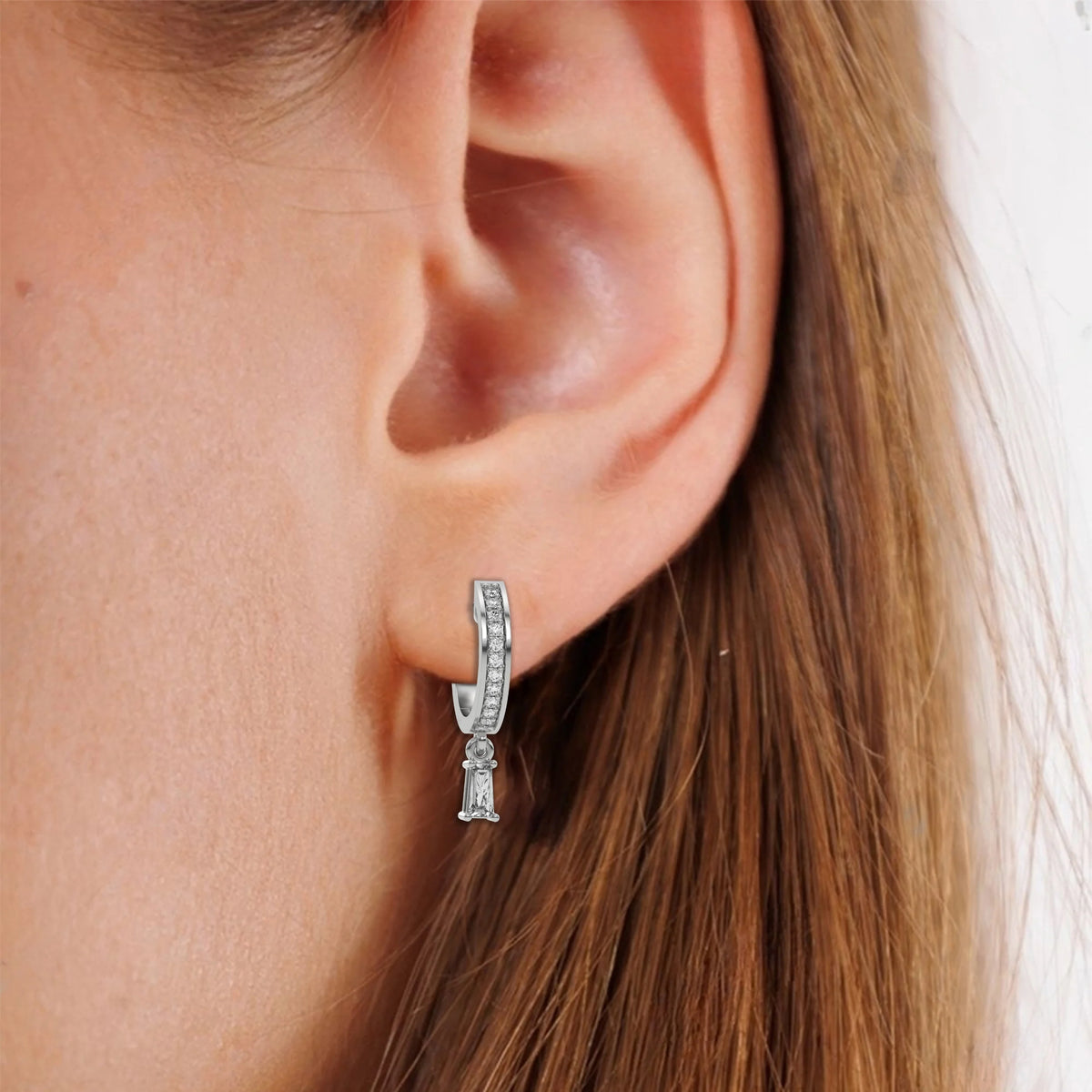 This white gold Dangling Baguette Diamond Hoop Earrings handmade with round brilliant-cut diamonds in pave setting and a baguette solitaire hanging at the bottom