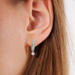 This white gold Dangling Round Diamond Hoop Earrings handmade with round brilliant-cut diamonds in pave setting and a round solitaire hanging at the bottom