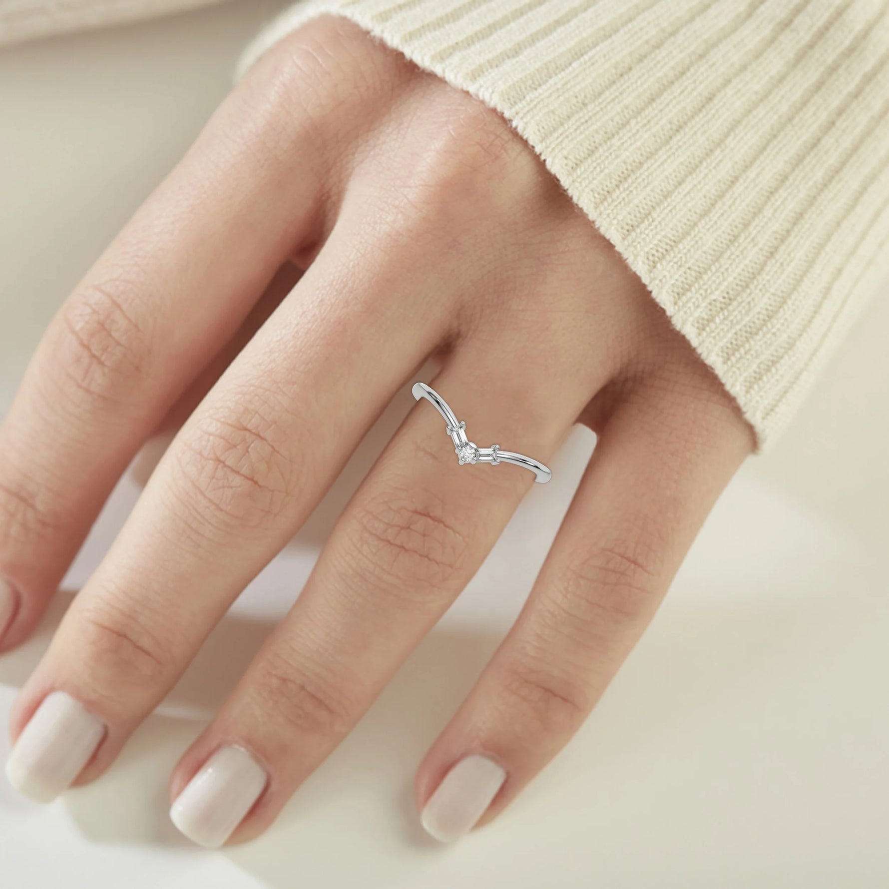 This white gold Chevron Diamond Ring handmade with round brilliant-cut diamonds and baguette diamonds all set in a shared prong setting on ring finger