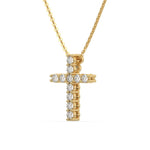 Side-profile view of a yellow gold cross pendant round diamond necklace with brilliant prong and pave-set stones