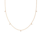 Modern yellow gold round diamond dangling necklace designed with three brilliant prong-set round stones on a fine link chain with a white background.