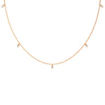 Modern rose gold round diamond dangling necklace designed with three brilliant prong-set round stones on a fine link chain with a white background.