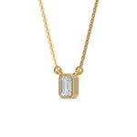 Side-angled view of a bezel-set Emerald Diamond necklace highlighting the solid yellow gold solitaire pendant setting with a white background.