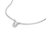 High-angle view of a bezel-set Emerald Diamond necklace featuring a step-cut solitaire stone in yellow gold.