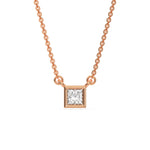 Sparkling bezel-set princess Diamond necklace crafted in rose gold with a square solitaire pendant with a white background.