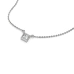 Angled view of a bezel-set princess Diamond necklace featuring a square solitaire diamond in a yellow gold frame with a white background.
