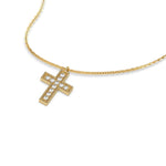 Side view of a 18K yellow gold cross pendant on a round diamond necklace featuring brilliant pave-set stones.