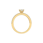 This yellow gold ring displayed in through finger view is made with a emerald solitaire diamond set in four-prong setting