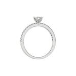 This white gold ring displayed in through finger view is made with a emerald solitaire diamond set in four-prong setting