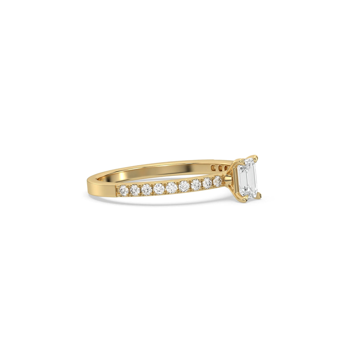 This yellow gold ring displayed in side view is made with a emerald solitaire diamond set in four-prong setting