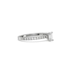 This white gold ring displayed in side view is made with a emerald solitaire diamond set in four-prong setting