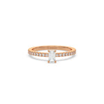 This rose gold ring displayed in front view is made with a emerald solitaire diamond set in four-prong setting