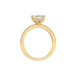 This yellow gold ring displayed in through finger view is made with a emerald solitaire diamond set in four-prong setting