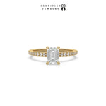 This yellow gold ring displayed in front view is made with a emerald solitaire diamond set in four-prong setting