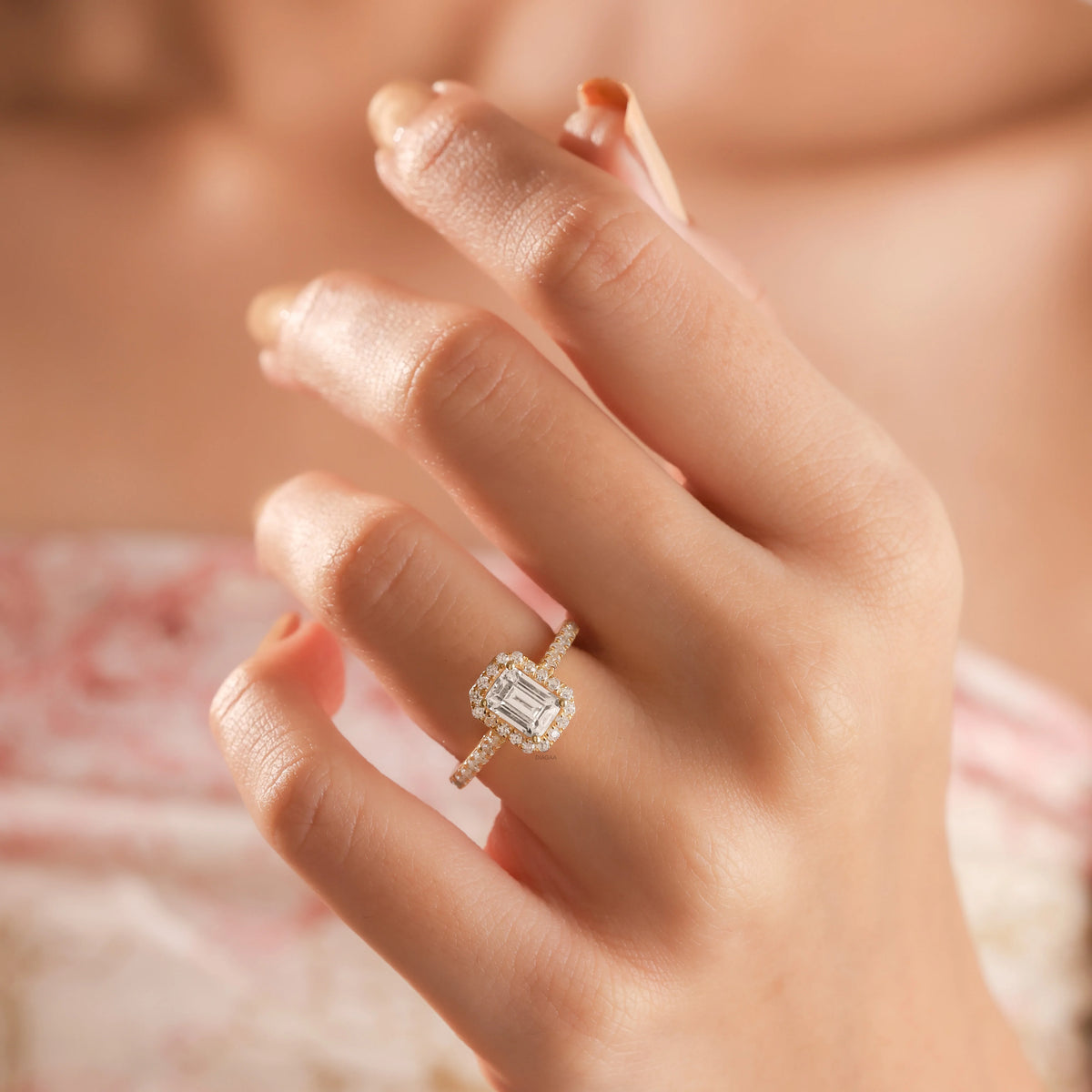 14k Yellow gold engagement ring with an emerald cut diamond center, a sparkling round diamond pave and halo setting a matching band.