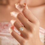 14k Yellow gold engagement ring with an emerald cut diamond center, a sparkling round diamond pave and halo setting a matching band.