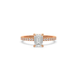 This rose gold ring displayed in front view is made with a emerald solitaire diamond set in four-prong setting