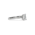 This white gold ring displayed in side view is made with a emerald solitaire diamond set in four-prong setting