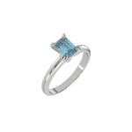 This white gold ring features an fancy Blue emerald solitaire diamond elegantly secured in a four-prong setting on a solid gold band in 3D view