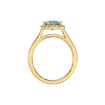 This yellow gold ring features a fancy Blue round solitaire diamond set in a four-prong setting in through finger view