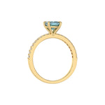 This yellow gold ring displayed in through finger view is made with a cushion solitaire diamond set in four-prong setting