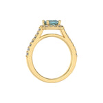 This yellow gold Cushion Diamond Halo Engagement Ring is made with a fancy Blue cushion solitaire diamond set in a four-prong setting in through finger view