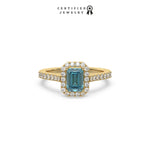 This yellow gold ring displayed in front view is made with a Emerald solitaire diamond set in four-prong setting