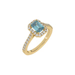 This yellow gold Emerald Diamond Halo Engagement Ring is made with a fancy blue emerald solitaire diamond set in a four-prong setting in 3D view