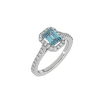 This white gold Emerald Diamond Halo Engagement Ring is made with a fancy blue emerald solitaire diamond set in a four-prong setting in 3D view