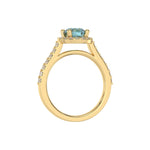 This yellow gold Round Diamond Halo Engagement Ring is made with a fancy Blue round solitaire diamond set in a four-prong setting in through finger view