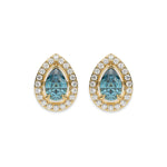 18k yellow gold Pear Diamond Halo Earrings made with a fancy Blue pear cut solitaire diamonds set in a four prong setting.