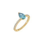 This yellow gold ring is made with a fancy Blue pear solitaire diamond set in three-prong setting, and is complemented by a round pave diamonds band in 3D view