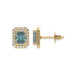 18k Yellow gold Radiant Diamond Halo Earrings made with a fancy blue radiant cut solitaire diamond set in a four prong setting.